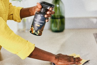 Person using Grounded multipurpose cleaning spray to wipe down a kitchen surface