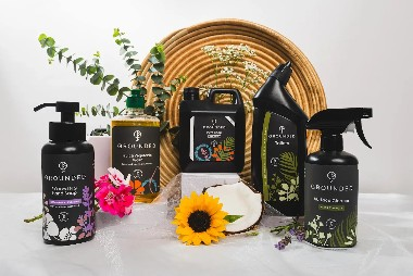 Range of Grounded non-toxic household cleaning products displayed with flowers and natural greenery